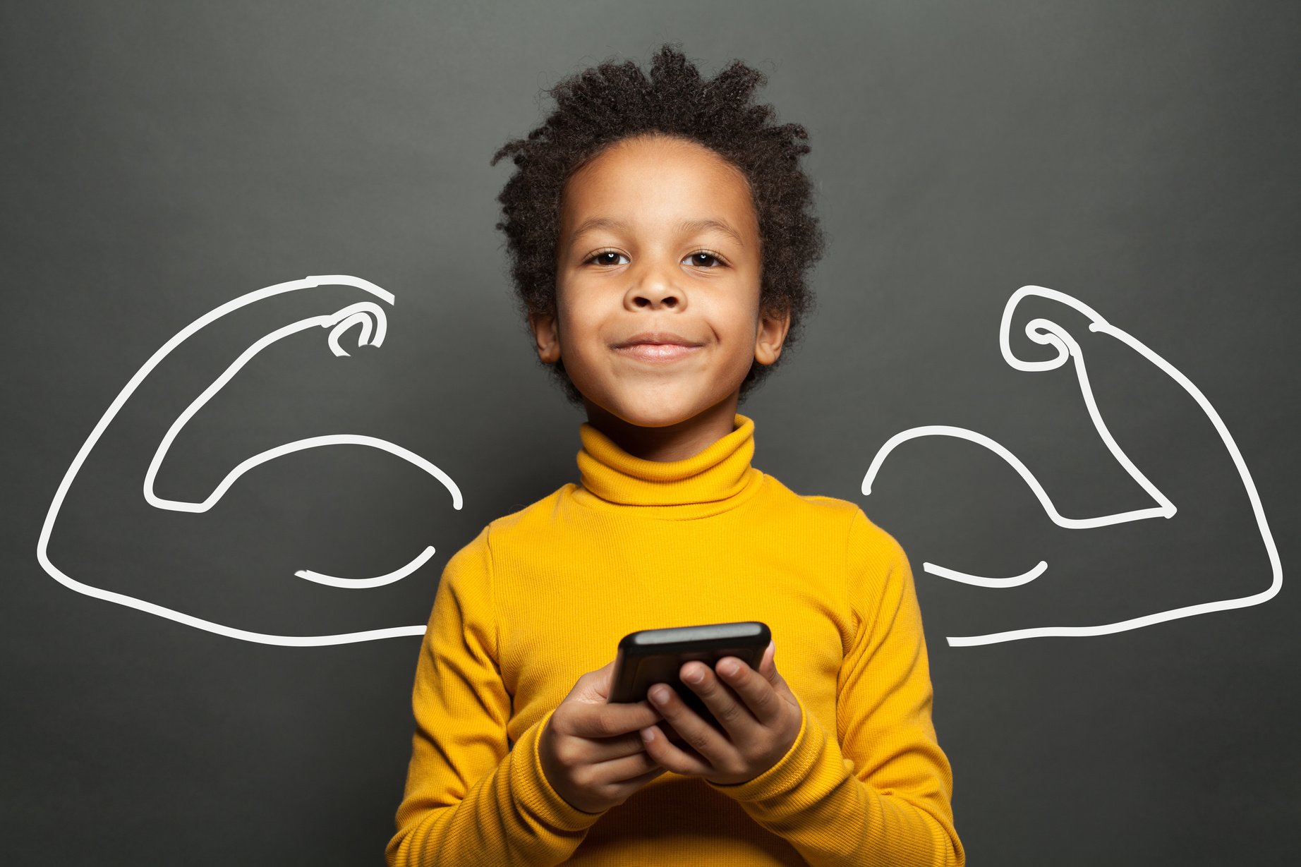 a child holding a calculator with a fulfilled expression and is standing against a drawing on a blackboard of muscular arms.