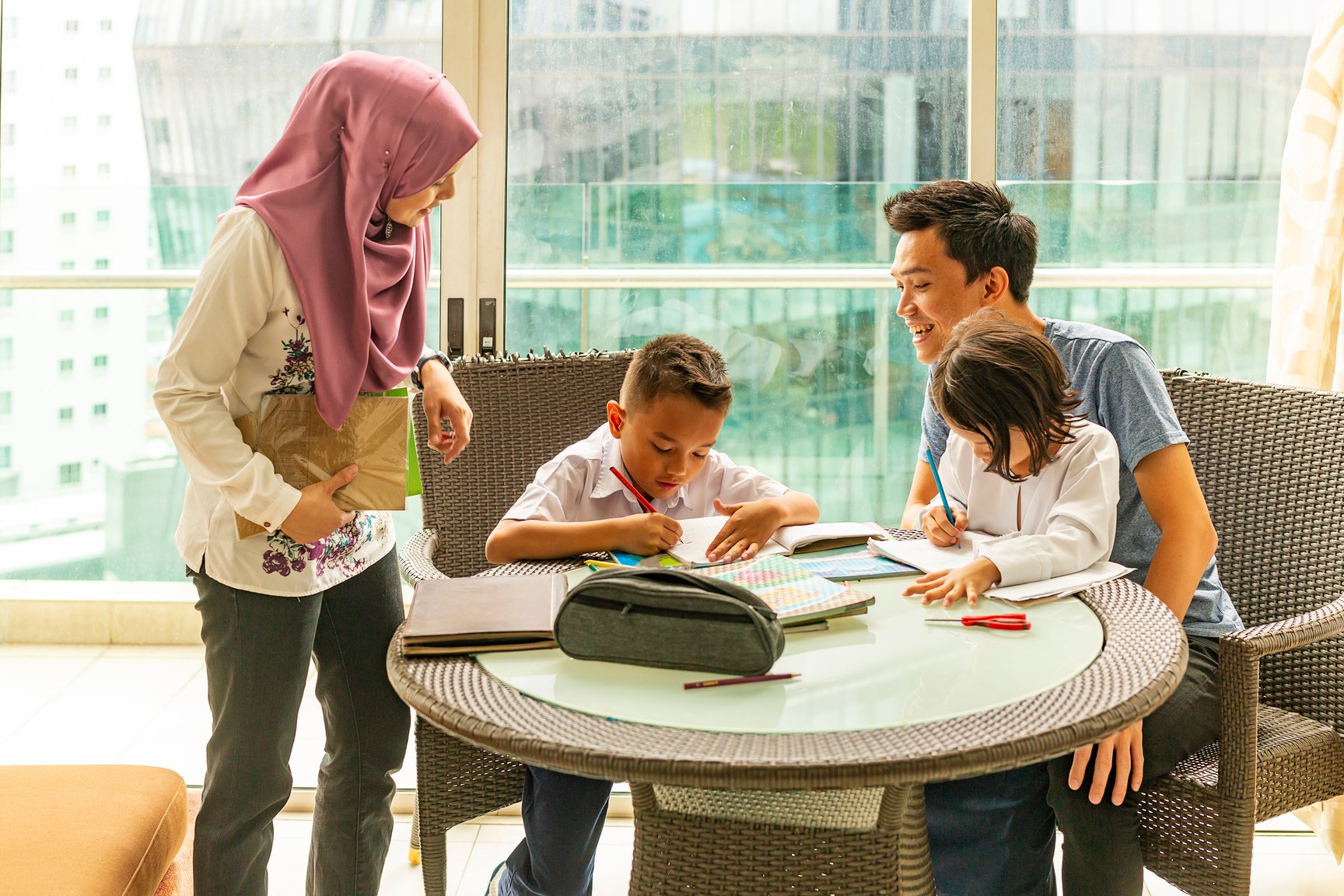 Asian Muslim Family Doing Homework Together